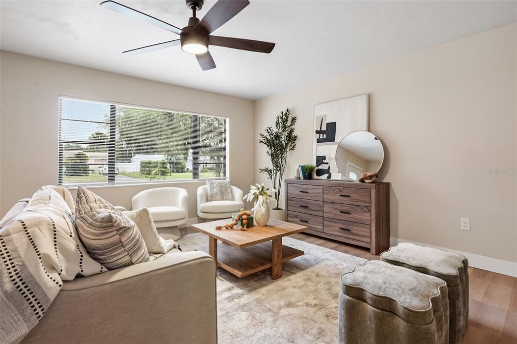 A living room features a sofa, two white chairs, a wooden coffee table, and a dresser — 1348 RADCLYFFE ROAD, ORLANDO, FL