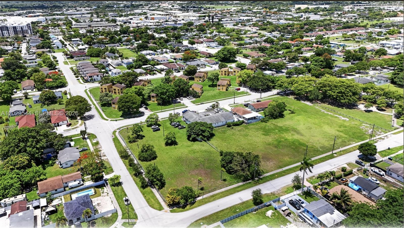 An aerial view shows a large grassy lot with a building surrounded by residential streets — 10330 SW 178th St, Miami FL 33157, MIAMI, FL