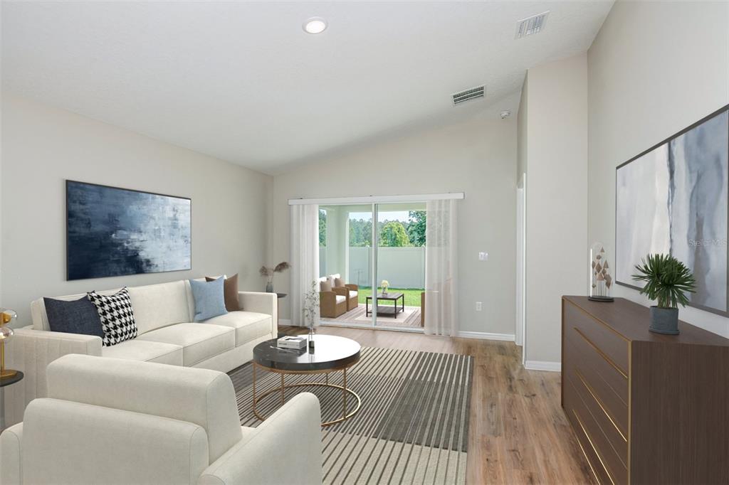 This digital rendering shows a living room with a sofa, coffee table, and sliding glass doors — 5393 SAN PIETRO DRIVE, WINTER HAVEN, FL