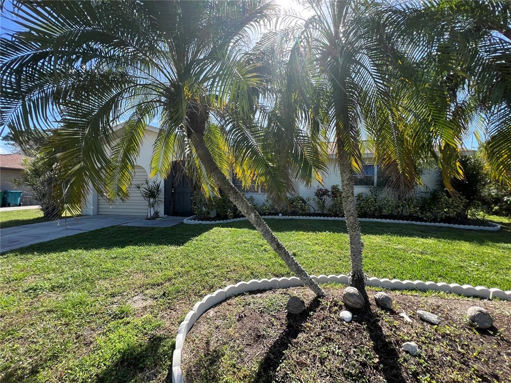 A single-story house with a palm tree in the front yard and a paved driveway — 18493 LAKE WORTH BOULEVARD, PORT CHARLOTTE, FL