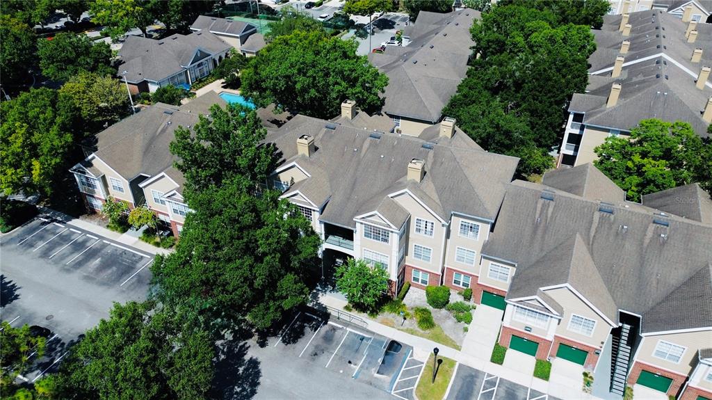 An aerial view shows a multi-story apartment complex with parking lots and surrounding trees — 13003 PLANTATION PARK CIRCLE UNIT 13110, ORLANDO, FL
