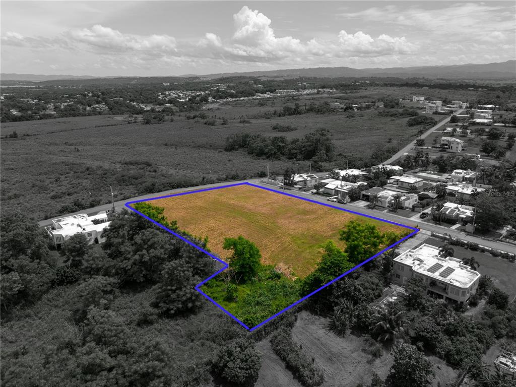 An aerial view shows a vacant, rectangular plot of land outlined in blue — URB. MIRADERO INTERIOR CALLE PLAYAS, CABO ROJO, PR