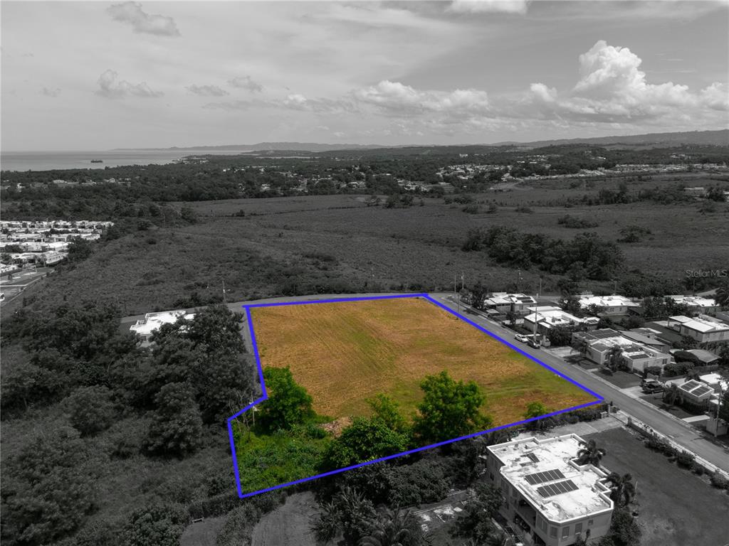 An aerial view shows a vacant, rectangular plot of land outlined in blue — URB. MIRADERO INTERIOR CALLE PLAYAS, CABO ROJO, PR