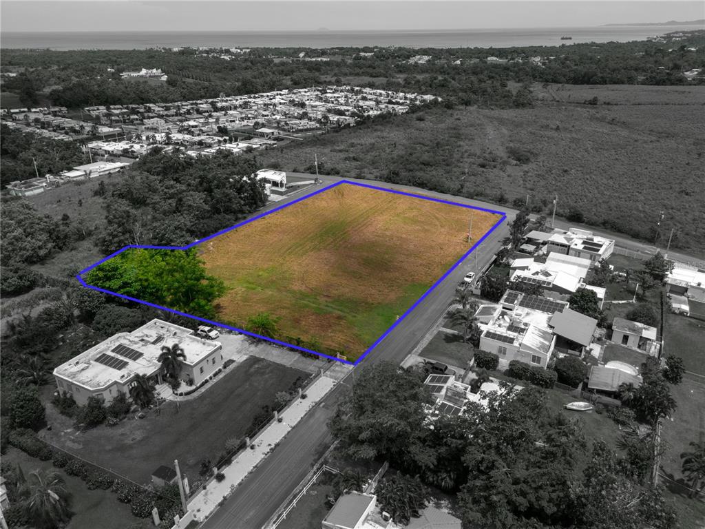 An aerial view shows a vacant, rectangular plot of land outlined in blue — URB. MIRADERO INTERIOR CALLE PLAYAS, CABO ROJO, PR