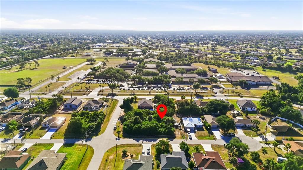 An aerial view shows a vacant, tree-covered residential lot marked with a red pin — 109 SIDNEY COURT, ROTONDA WEST, FL