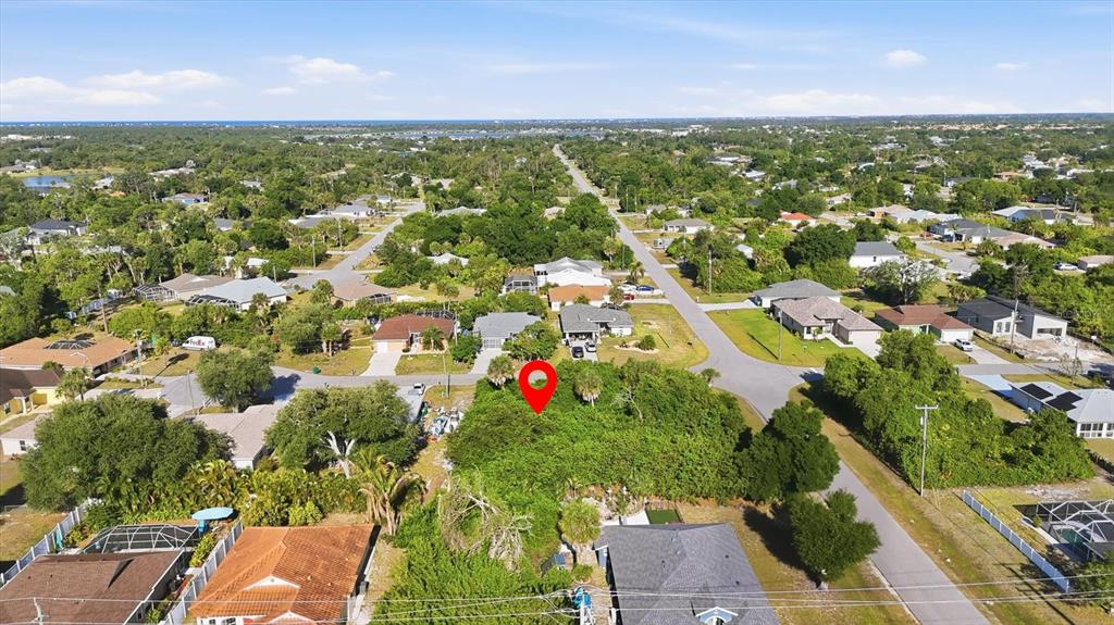 An aerial view shows a vacant, tree-covered residential lot marked with a red pin — 109 SIDNEY COURT, ROTONDA WEST, FL