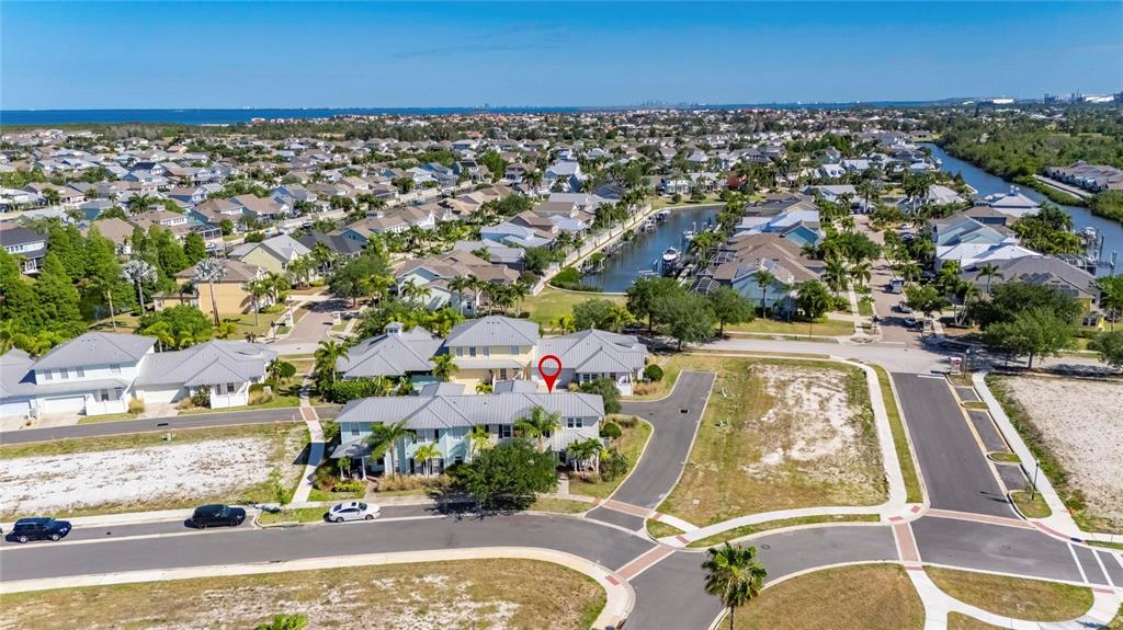 An aerial view shows a multi-unit residential building with a red location pin — 5536 LUMINAR POINTE LANE, APOLLO BEACH, FL