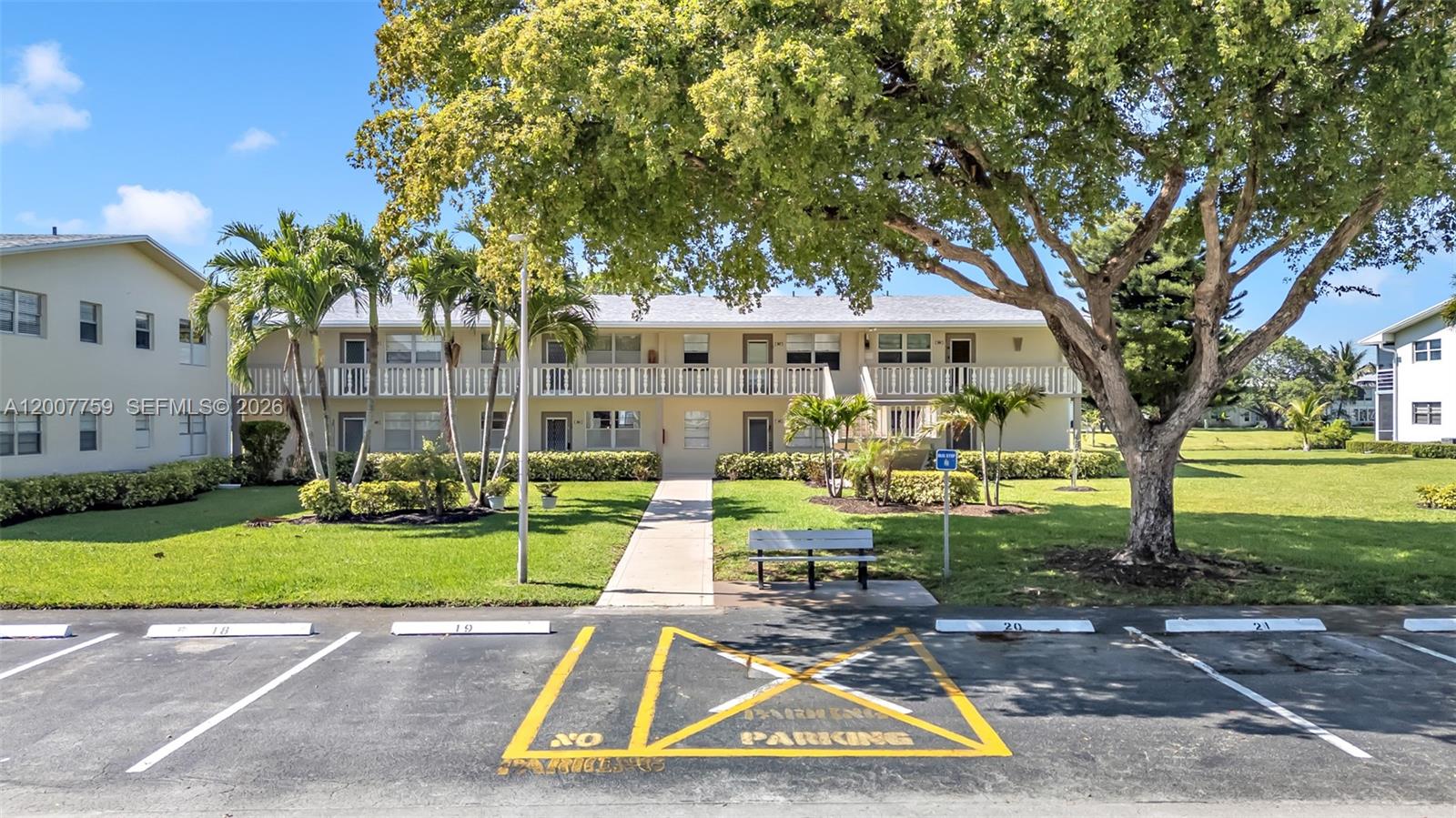 A two-story apartment building features a paved parking lot with a marked no-parking zone — 494 W Tilford  W # 494, Deerfield Beach FL 33442, DEERFIELD BEACH, FL
