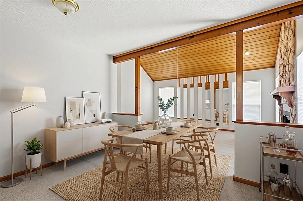 A dining room features a wooden table, wishbone chairs, a sideboard, and a vaulted wood ceiling — 10207 N HYALEAH ROAD, TAMPA, FL