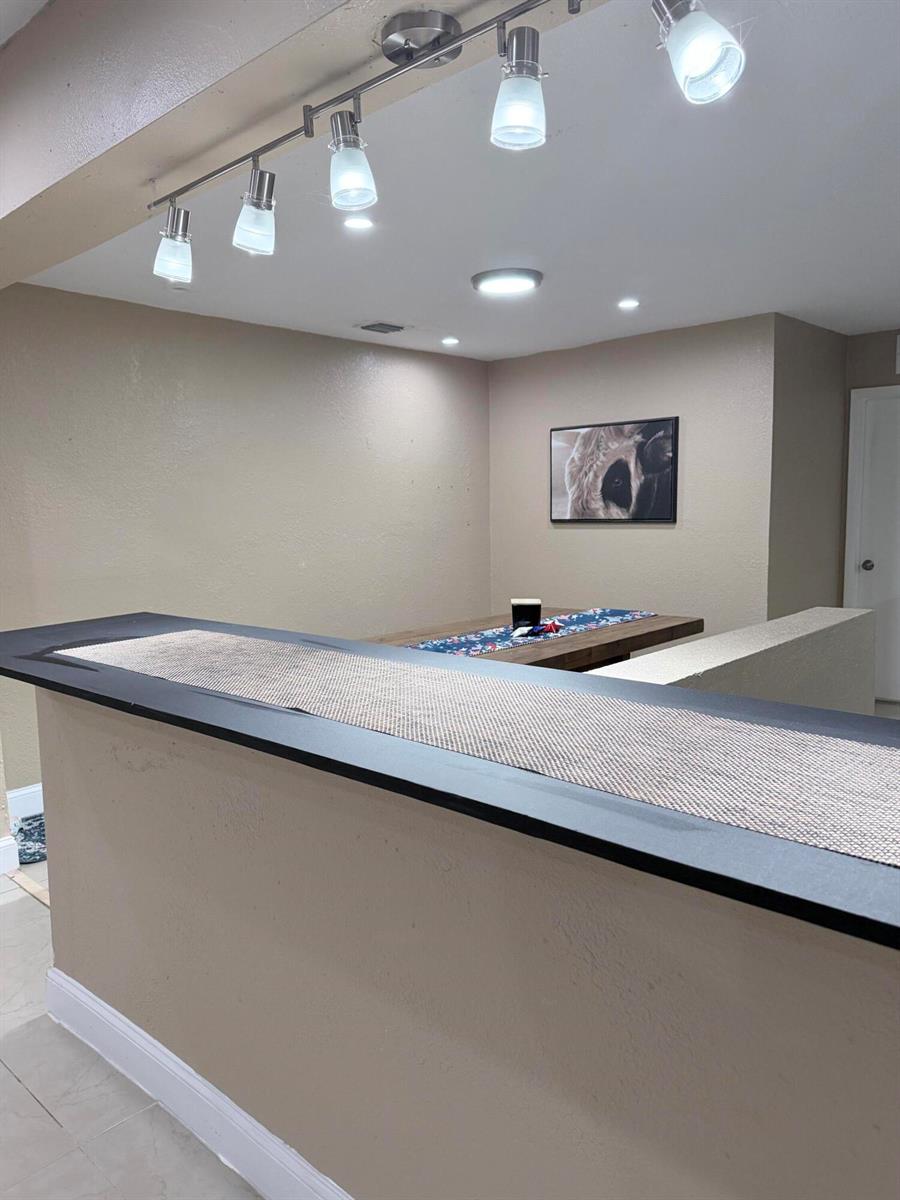 A bar counter with a dark top sits in front of a dining area — 2000 SW 95th Terrace, Miramar FL 33025, MIRAMAR, FL