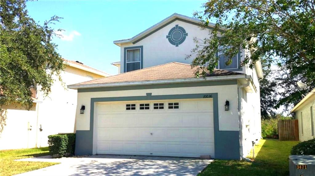A two-story house with a white stucco exterior, a two-car garage, and a brown roof — 10036 PERTHSHIRE CIRCLE, LAND O LAKES, FL