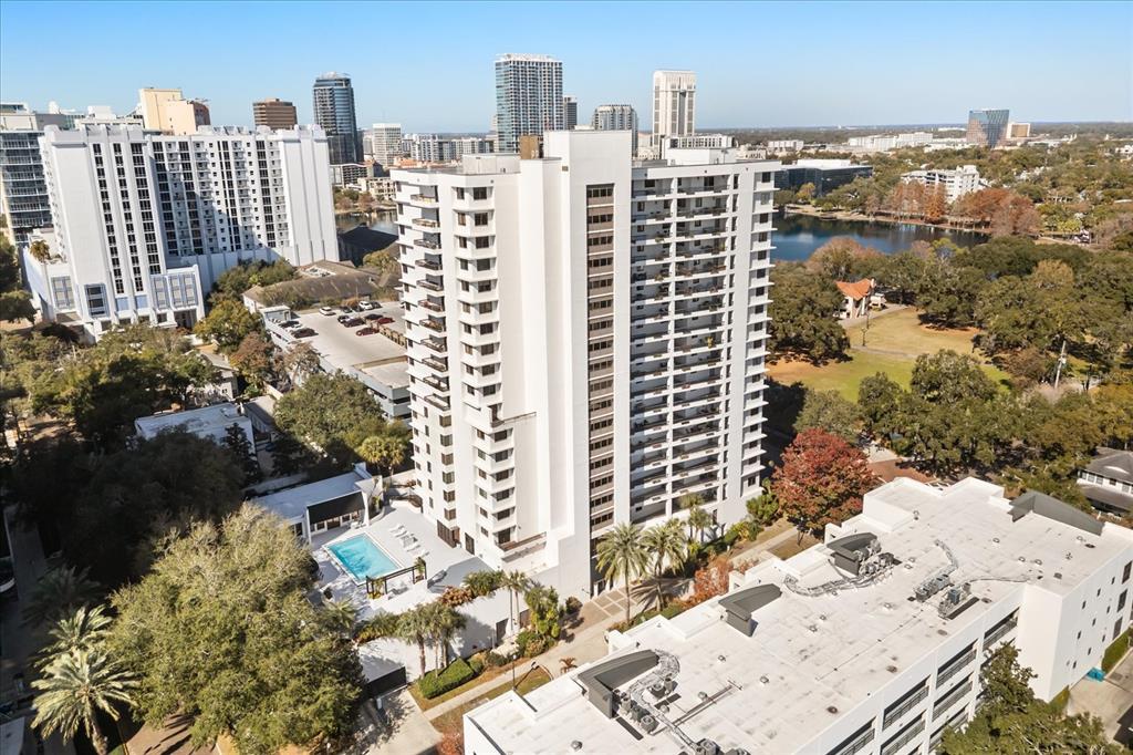 An aerial view shows a tall white apartment building with a pool and parking garage — 530 E CENTRAL BOULEVARD UNIT 1901, ORLANDO, FL