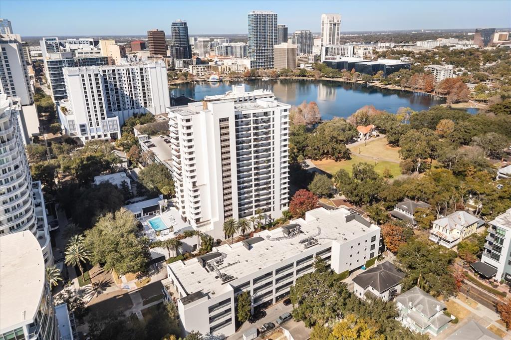 An aerial view shows a high-rise apartment building next to a lake and city skyline — 530 E CENTRAL BOULEVARD UNIT 1901, ORLANDO, FL