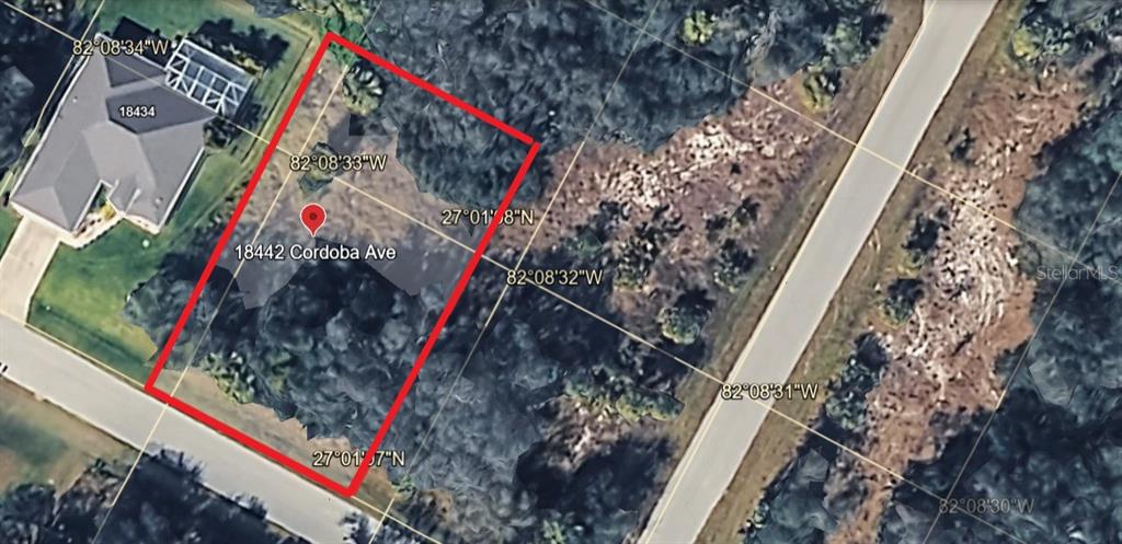 This aerial map shows a vacant, wooded residential lot outlined in red — 18442 CORDOBA AVENUE, PORT CHARLOTTE, FL