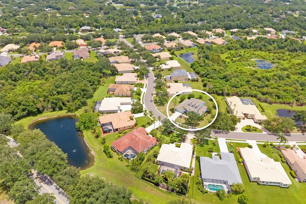 An aerial view shows a residential neighborhood with a circled single-story house and ponds — 1111 BRAMBLING COURT, BRADENTON, FL