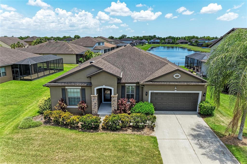 An aerial view of a single-story suburban house with a brown roof and garage — 11101 58TH STREET CIRCLE E, PARRISH, FL