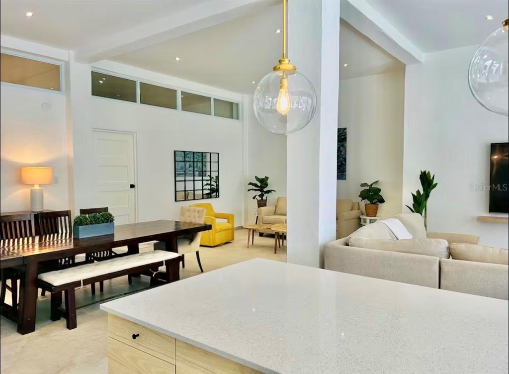 A bright, open-concept living and dining area features white walls, light flooring, and modern lighting — 107 LOIZA, SAN JUAN, PR