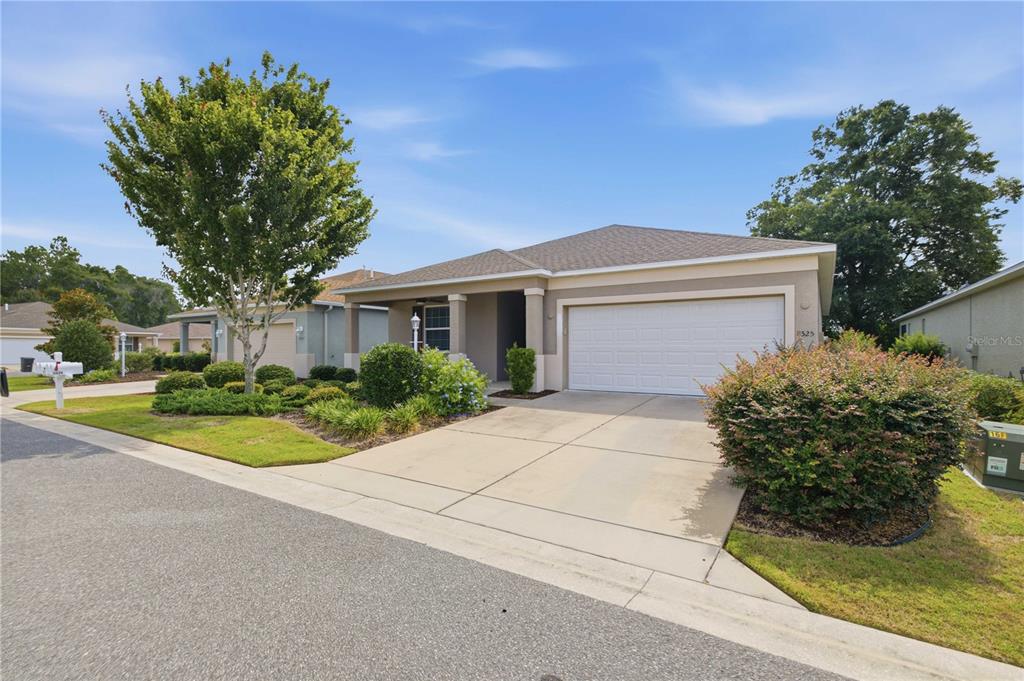 A single-story suburban house with a two-car garage, concrete driveway, and landscaped front yard — 8525 SW 79TH AVENUE, OCALA, FL