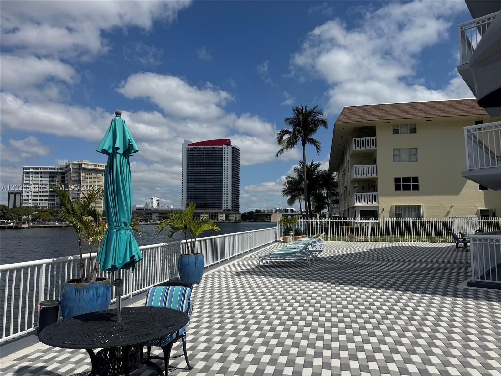 A patio with a checkered floor, outdoor furniture, and a view of the waterfront — 1913 S Ocean Dr # 427, Hallandale Beach FL 33009, HALLANDALE BEACH, FL