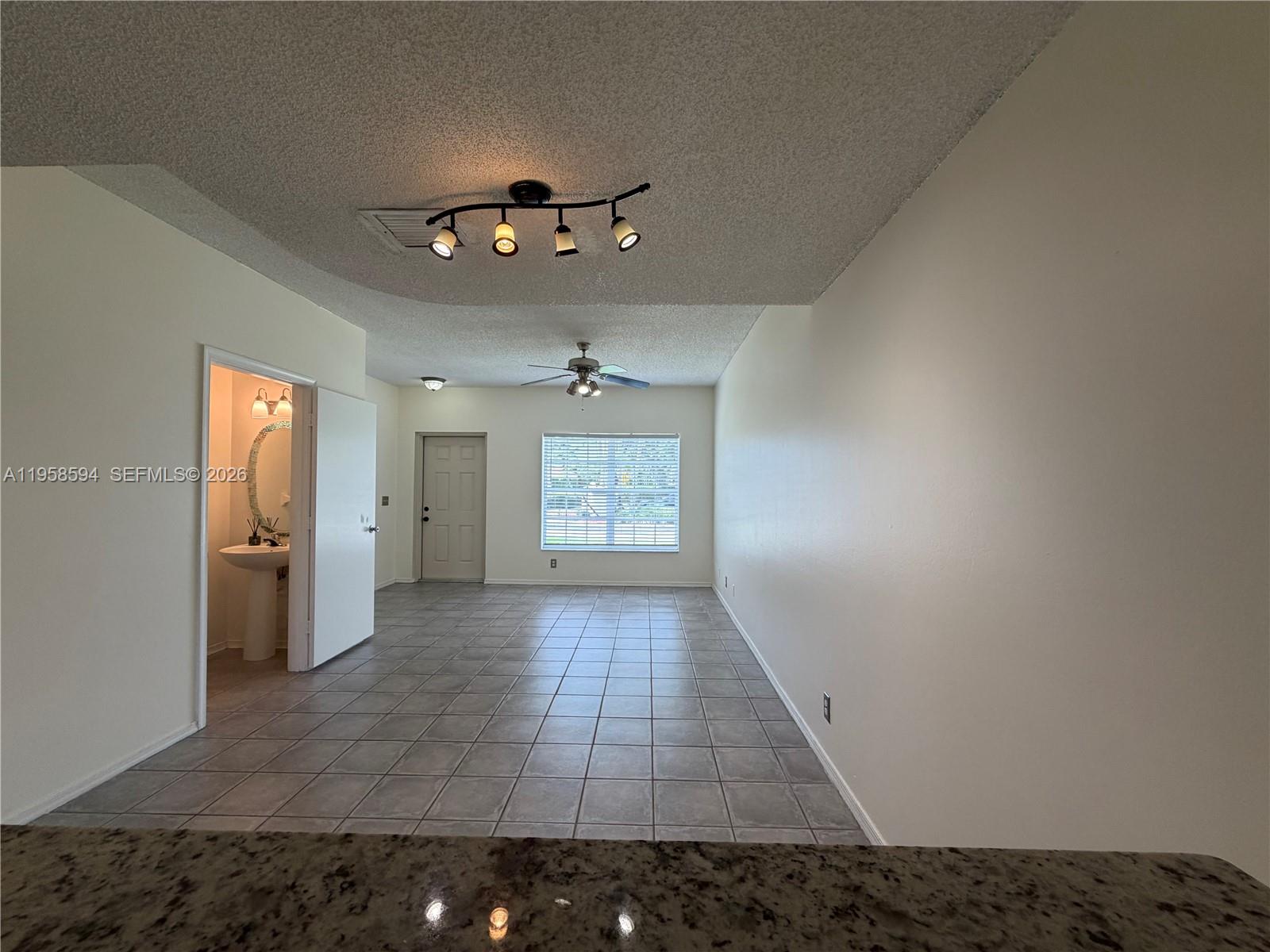 A tiled living area features a ceiling fan, track lighting, and an adjacent bathroom — 271 Duval Ct, Weston FL 33326, WESTON, FL