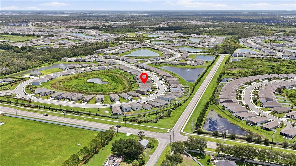 An aerial view shows a suburban neighborhood with houses, ponds, and a red location pin — 5051 GRANITE DUST PLACE, PALMETTO, FL