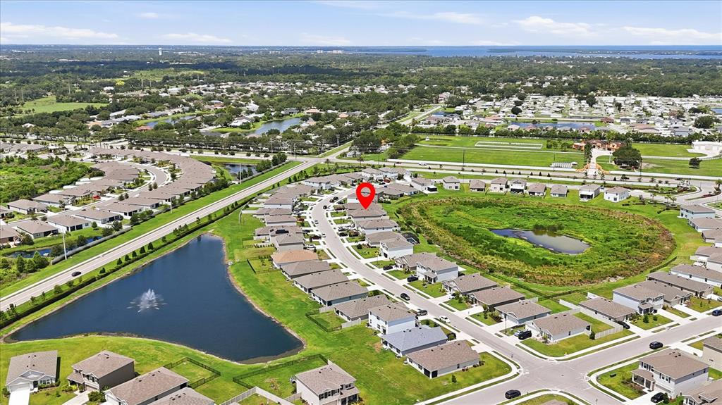 An aerial view shows a suburban neighborhood with houses, a pond, and a red location pin — 5051 GRANITE DUST PLACE, PALMETTO, FL