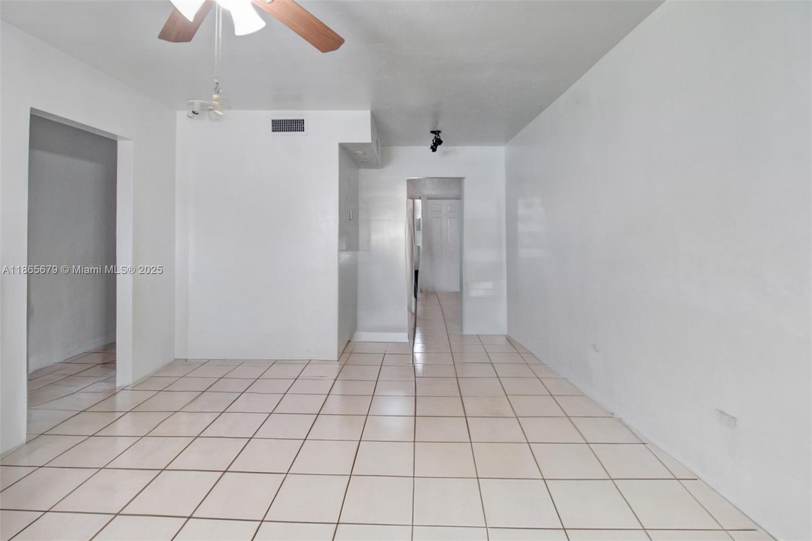 An empty room with white walls, tiled floors, and a ceiling fan — 3451 SW 11th St # 8A, Miami FL 33135, MIAMI, FL