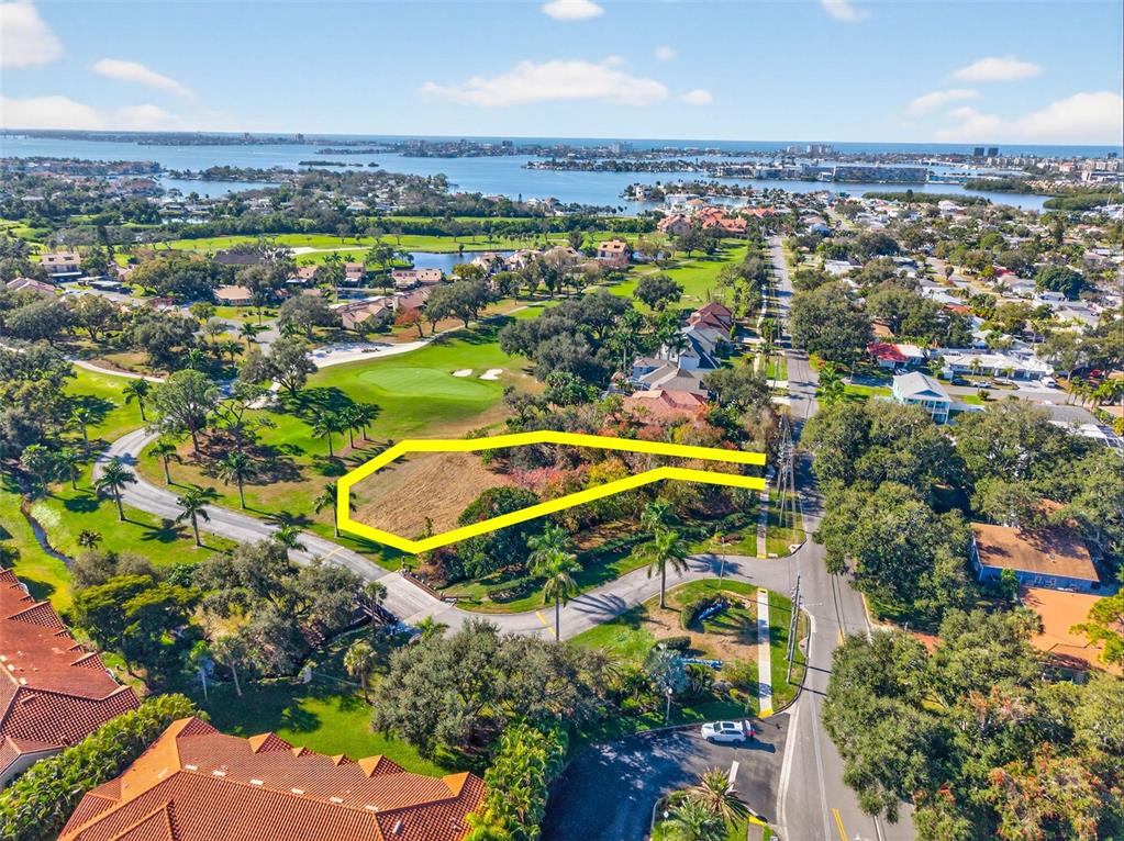 An aerial view shows a vacant, irregularly shaped lot bordered by a golf course and road — ROYAL PALM DRIVE S, GULFPORT, FL