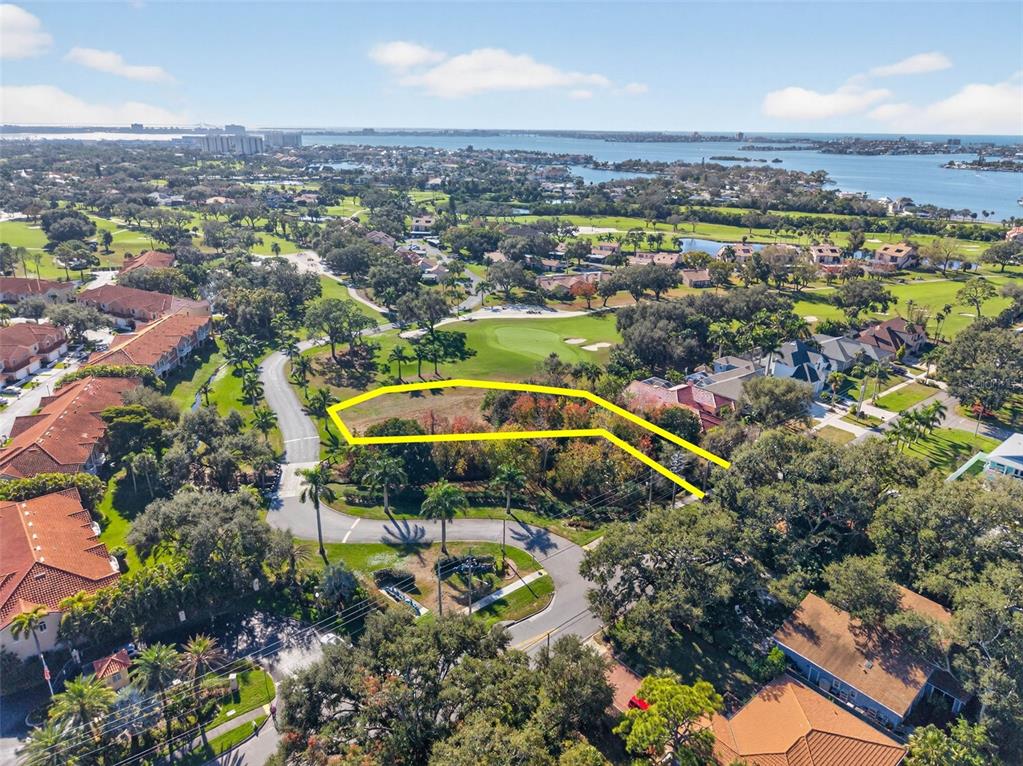 An aerial view shows a vacant lot outlined in yellow near a golf course — ROYAL PALM DRIVE S, GULFPORT, FL