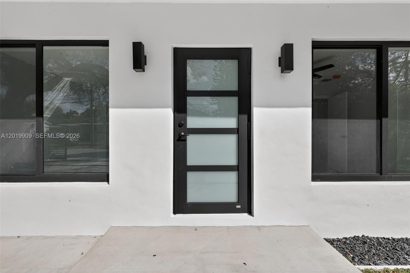 A modern front entrance features a frosted glass door flanked by two large windows — 53 NW 68th St, Miami FL 33150, MIAMI, FL