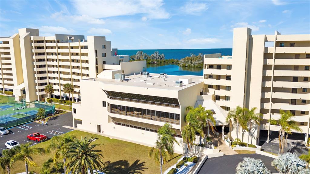 An aerial view shows two large residential buildings flanking a central structure near a bay — 6009 SEA RANCH DRIVE UNIT 307, HUDSON, FL
