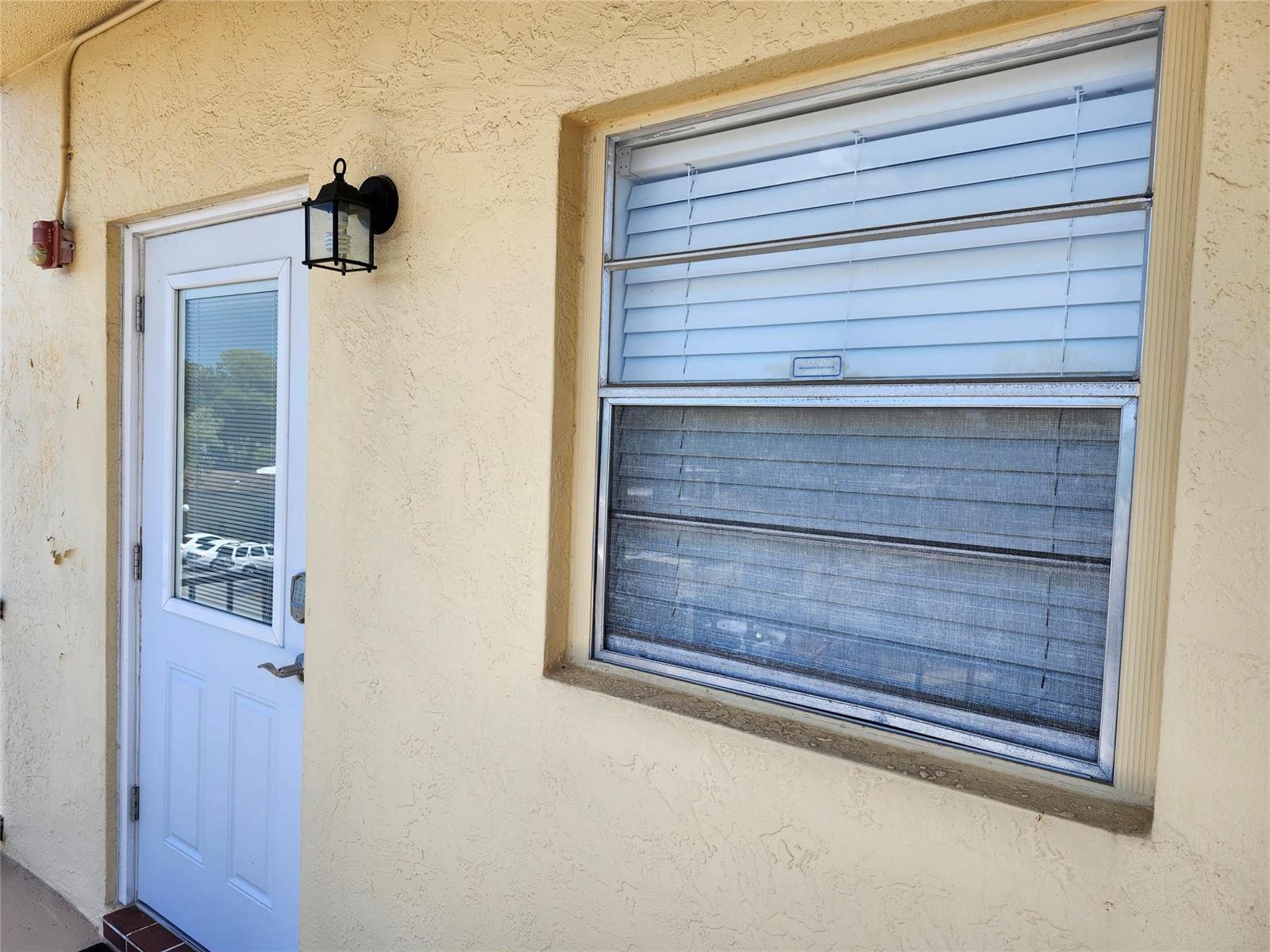 A white door with a keypad lock and a window with blinds on a stucco wall — 301 Cambridge Road # 301, Hollywood FL 33024, HOLLYWOOD, FL