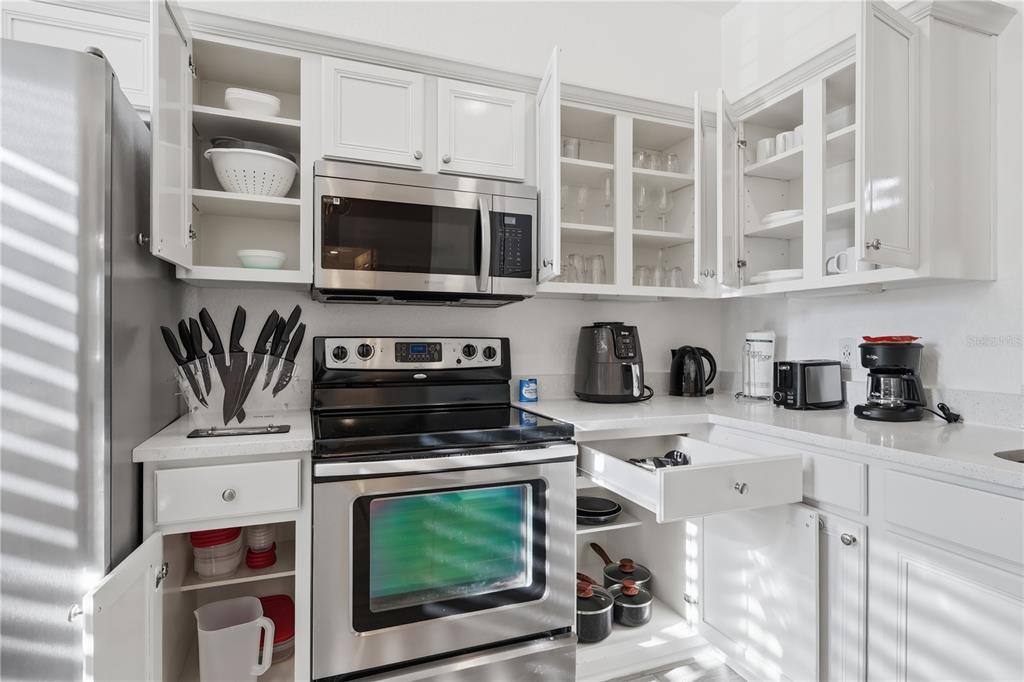 A kitchen features white cabinets, stainless steel appliances, and white countertops — 3438 CALABRIA AVENUE UNIT 3438, DAVENPORT, FL