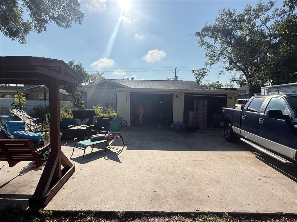 A concrete driveway leads to a two-car garage attached to a single-story house — 714 26TH STREET W, BRADENTON, FL