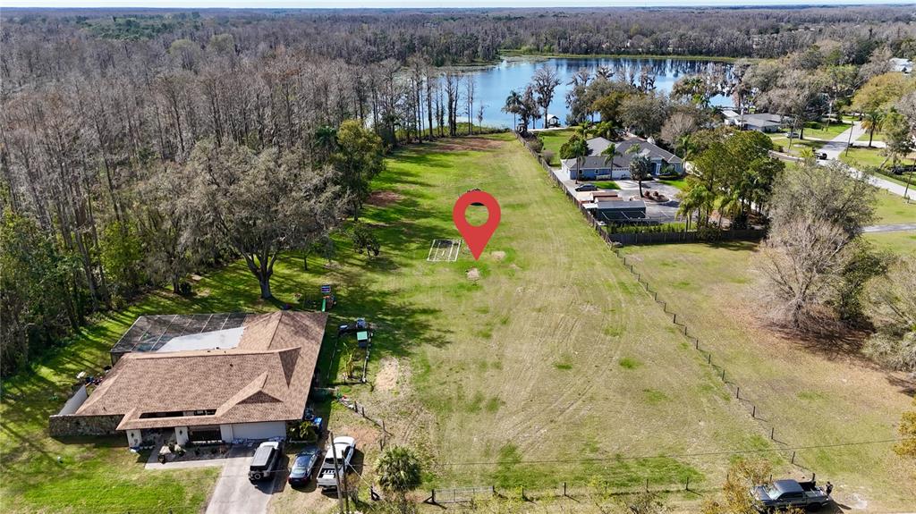 An aerial view shows a large grassy lot with a house and a red location pin — BLOUNT ROAD, LUTZ, FL