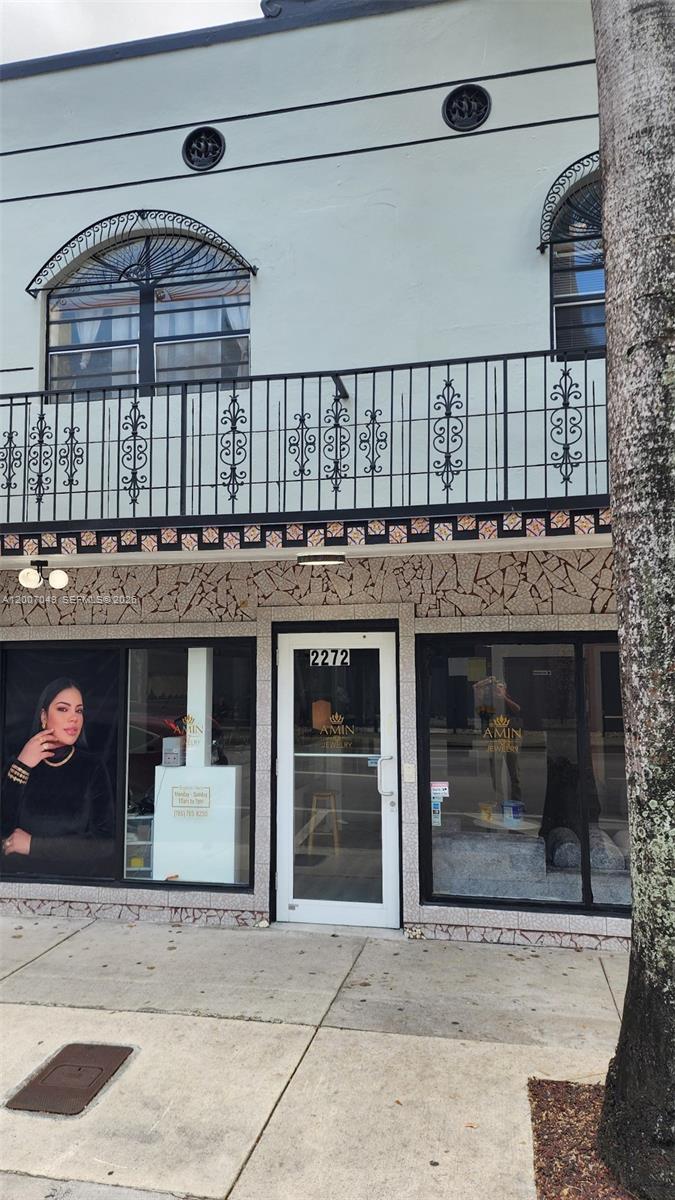 The exterior of a storefront features a glass door, large display windows, and a balcony — 2272 SW 8th St # 3, Miami FL 33135, MIAMI, FL