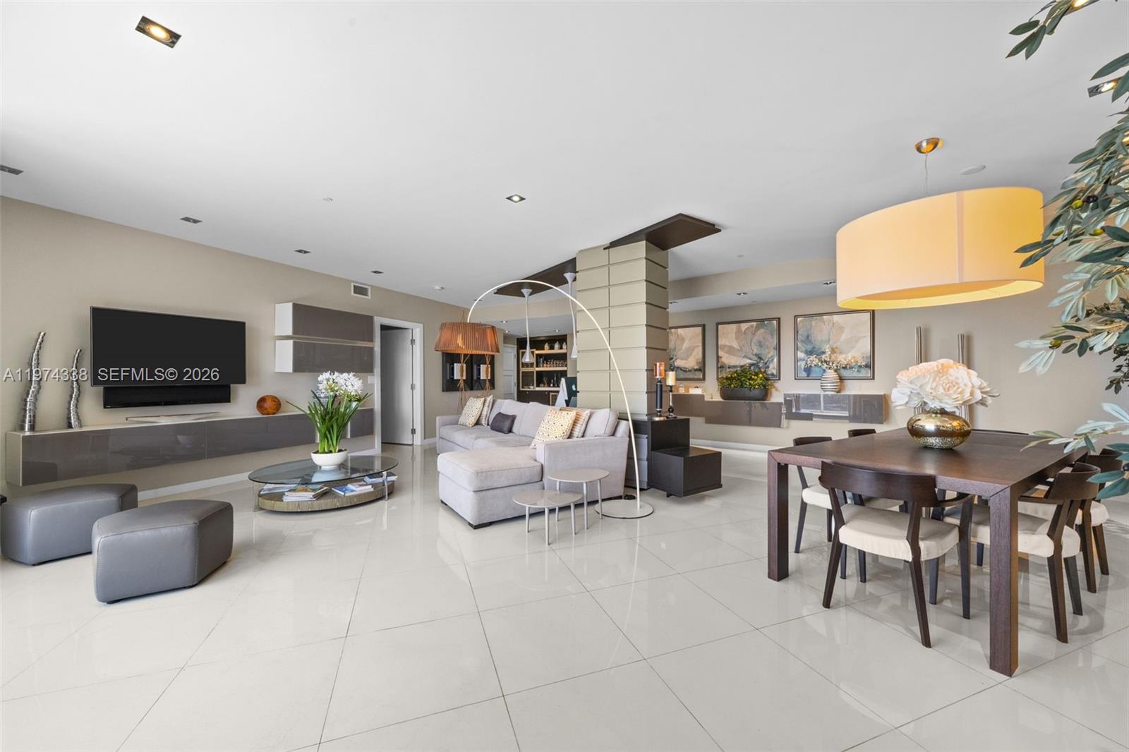 A modern living and dining area features white tile floors, a sectional sofa, and furniture — 9601 Collins Ave # 1208, Bal Harbour FL 33154, BAL HARBOUR, FL