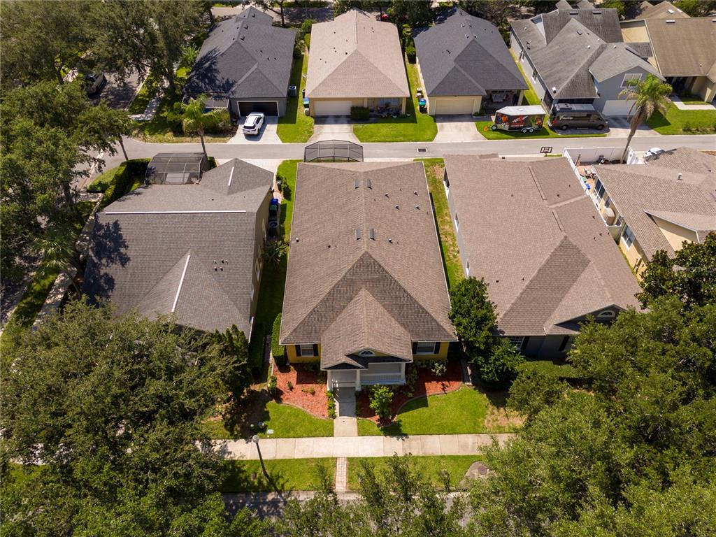 An aerial view shows a suburban house with a brown roof and a front yard — 7011 NOBLETON DRIVE, WINDERMERE, FL