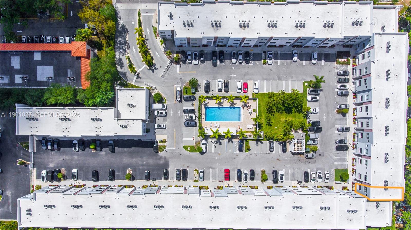 This aerial view shows a multi-story apartment complex with a central swimming pool and parking — 2555 NE 193rd St # 2224, Miami FL 33180, MIAMI, FL