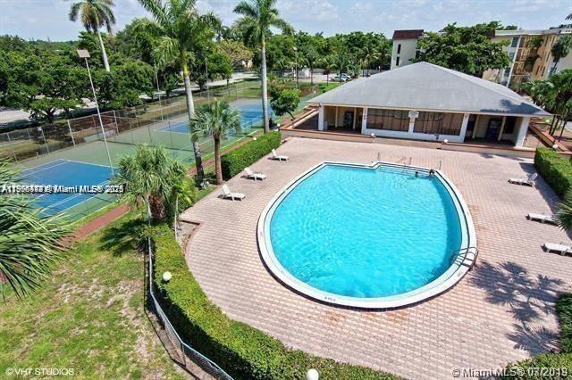 An aerial view shows a swimming pool, tennis courts, and a clubhouse with palm trees — 11905 NE 2nd Ave # C402, North Miami FL 33161, NORTH MIAMI, FL