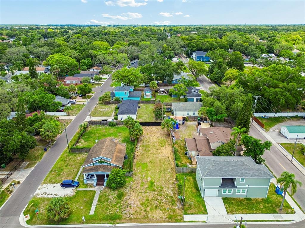 An aerial view shows a vacant residential lot situated between two houses on a street — 4805 N 10TH STREET, TAMPA, FL