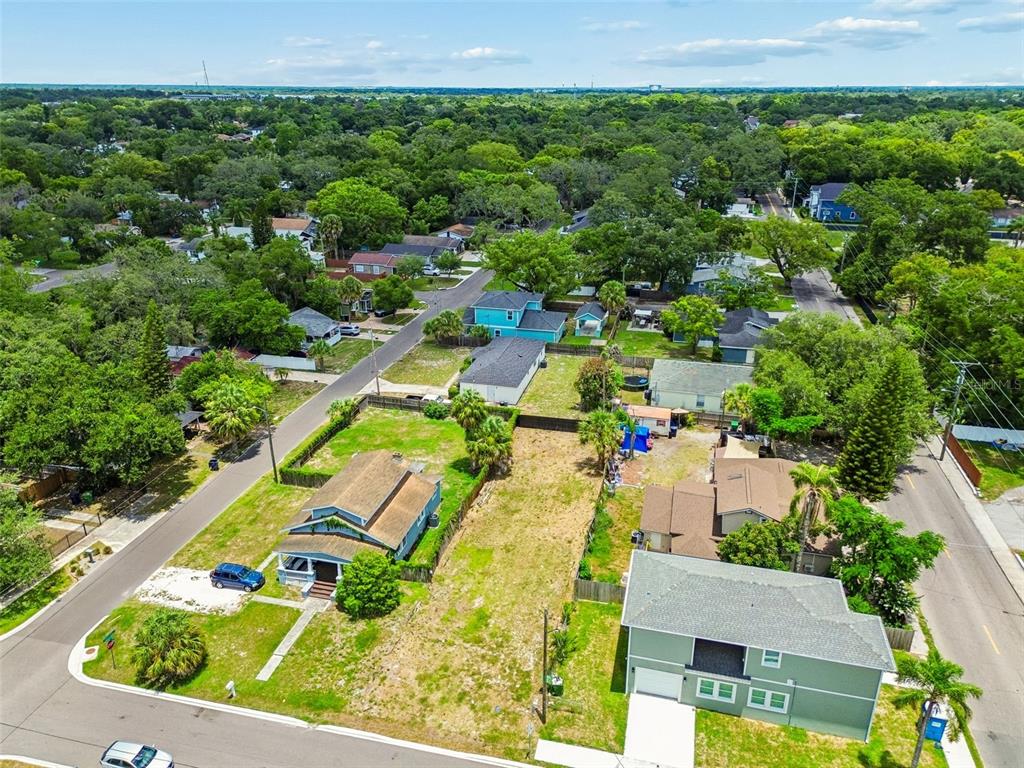 An aerial view shows a vacant residential lot situated between two houses on a street — 4805 N 10TH STREET, TAMPA, FL