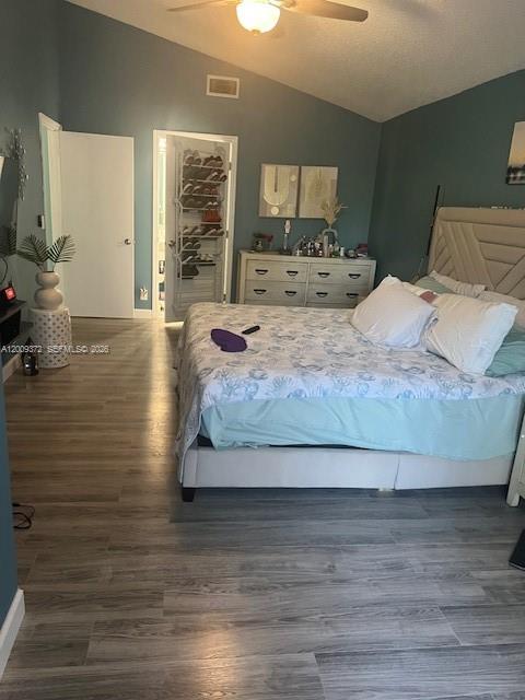 A bedroom features a bed with patterned bedding, a dresser, and light-colored wood-look flooring — 150 Colly Way, North Lauderdale FL 33068, NORTH LAUDERDALE, FL