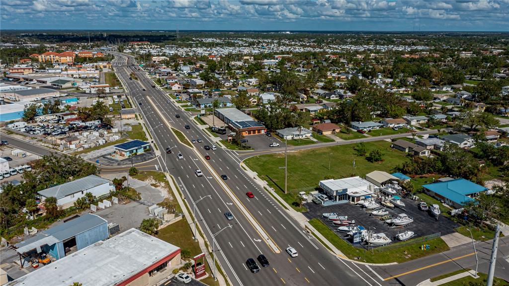 An aerial view shows a multi-lane highway running through a commercial and residential area — 601 US HIGHWAY 41 BYPASS S, VENICE, FL