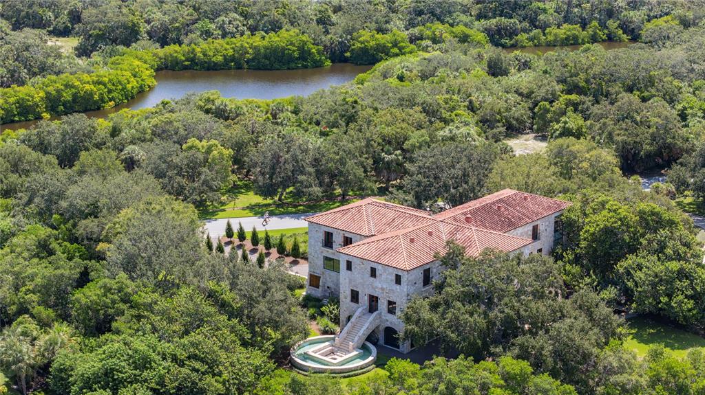 An aerial view of a stone mansion with a red tile roof and circular fountain — 1571 OCEANVIEW DRIVE, ST PETERSBURG, FL