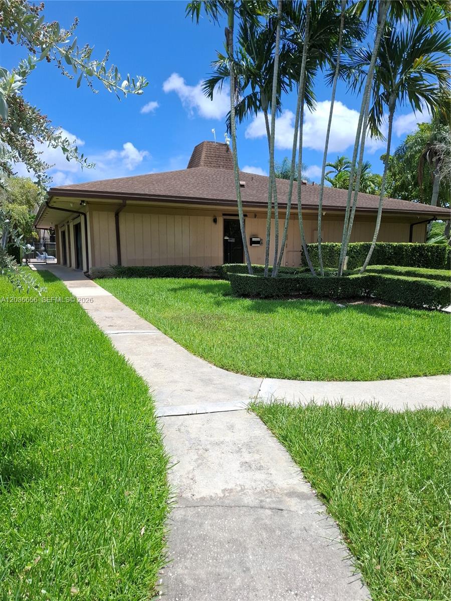 A single-story building with a brown roof and tan siding sits behind a manicured lawn — 10425 SW 112th Ave # 207, Miami FL 33176, MIAMI, FL