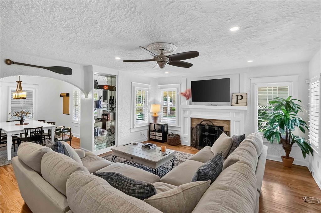 A living room features a sectional sofa, fireplace, ceiling fan, and an adjacent dining area — 2016 VIRGINIA DRIVE, BRADENTON, FL