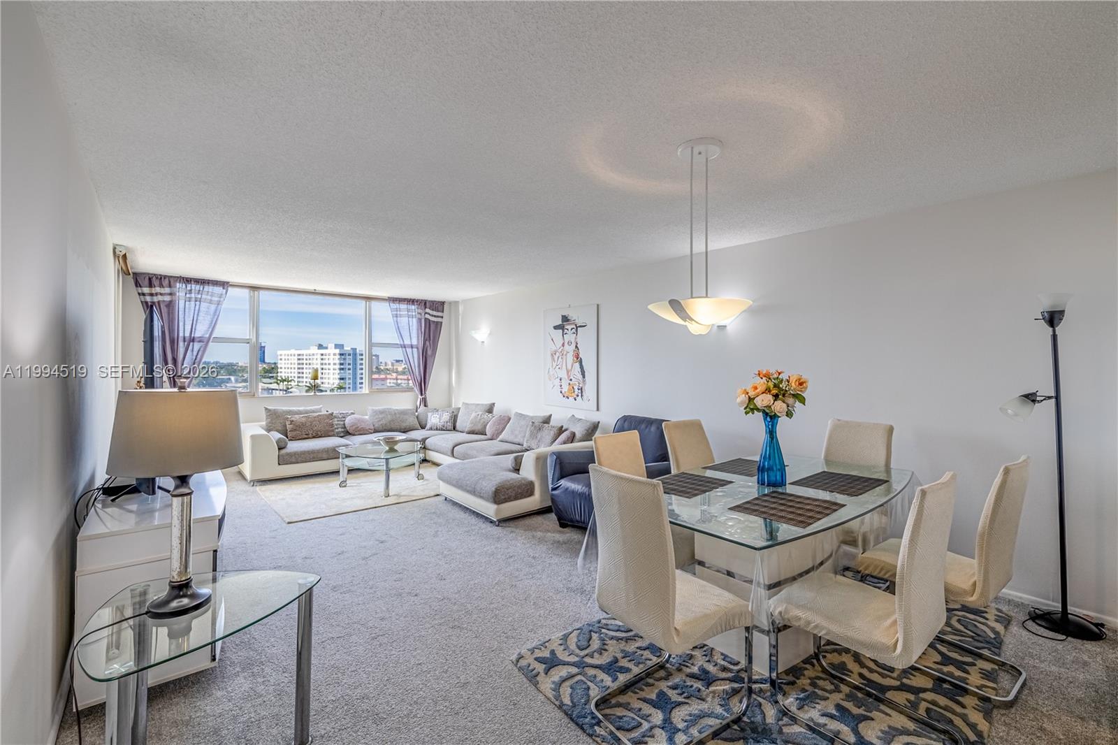 A sandy beach features rows of white umbrellas and lounge chairs along the oceanfront — 3180 S Ocean Dr # 718, Hallandale Beach FL 33009, HALLANDALE BEACH, FL
