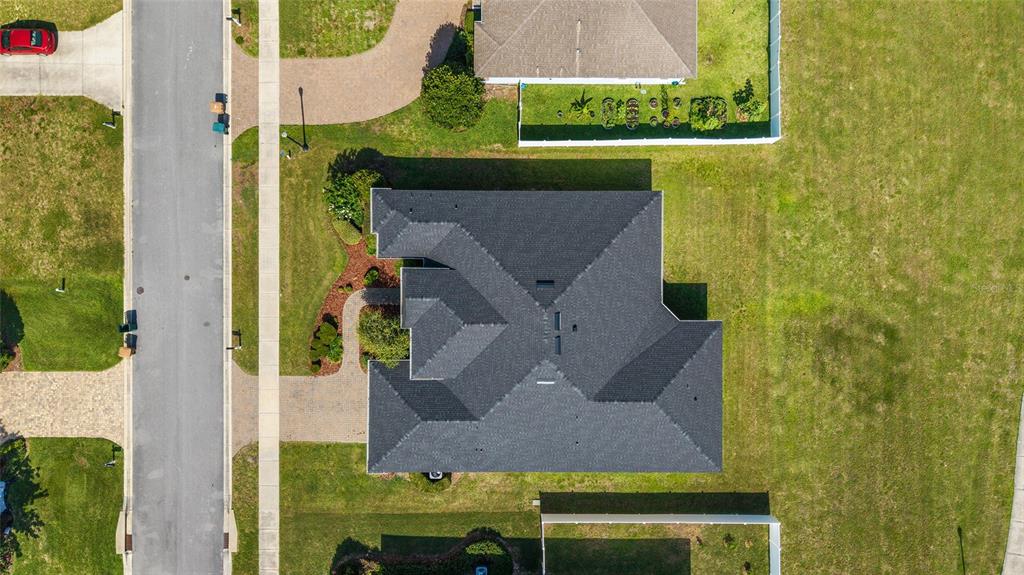 An aerial view shows a single-story house with a dark shingled roof and driveway — 4417 SW 65TH PLACE, OCALA, FL