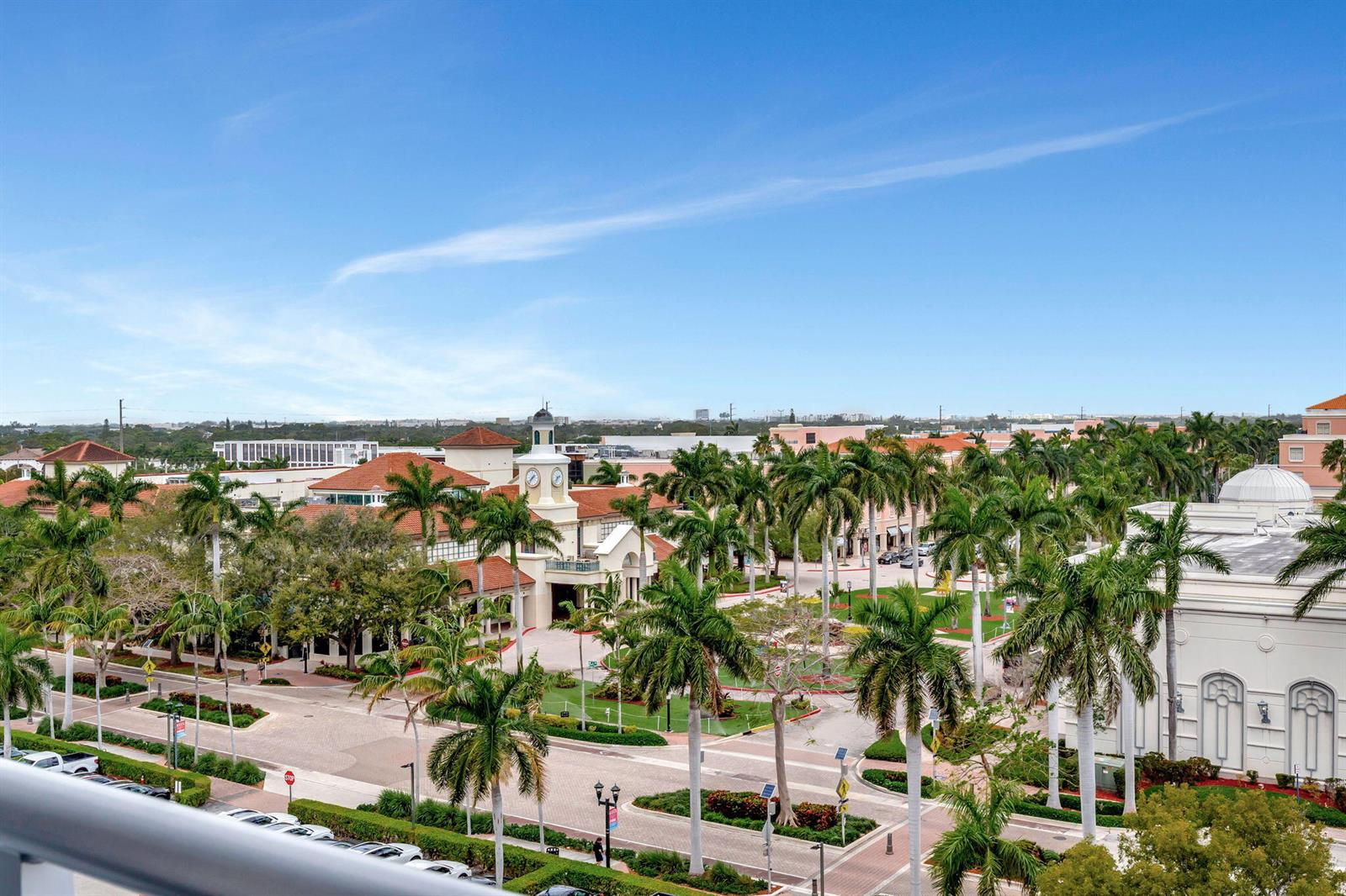 An elevated view of a palm-lined shopping center with a clock tower under a blue sky — 155 E Boca Raton Road # 719, Boca Raton FL 33432, BOCA RATON, FL